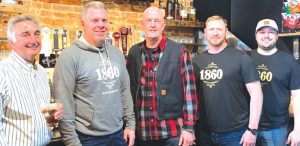 1860 Taproom and Bottleshop started giving a portion of its proceeds from its community tap handle to local organizations last February. Shown when the tap room started the fundraising last year are, from left, Northern Row partner Joe Maas, 1860 owner Doug Mangold, Harrison Fire Department Chief Rob Hursong, 1860 owner John Matheny, and 1860 General Manager DJ Zang. FILE PHOTO