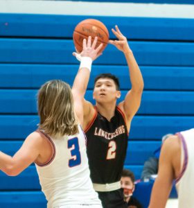 Lawrenceburg junior guard Garrett Yoon (2) shoots over Conner defender Riley Osterbur (3) in the basketball Tigers’ 64-46 loss at Hebron, Ky., Friday night, Jan. 22. (Betty Taylor/TaylorMadePhotography)