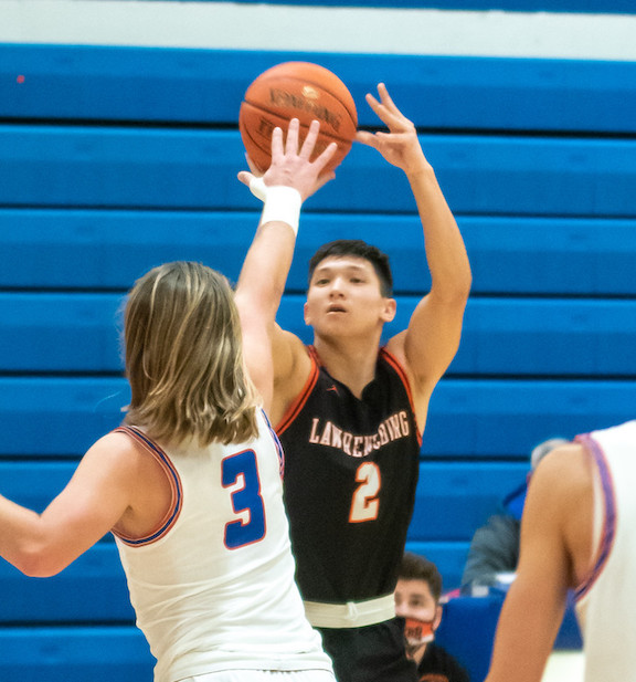 Lawrenceburg junior guard Garrett Yoon (2) shoots over Conner defender Riley Osterbur (3) in the basketball Tigers’ 64-46 loss at Hebron, Ky., Friday night, Jan. 22. (Betty Taylor/TaylorMadePhotography)
