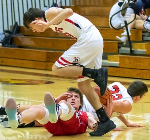 South Dearborn’s Eli Hoffman (bottom) maintains possession of the ball despite a 3-way collision with East Central’s Jadyn Dennis and John Hotel in Wednesday’s 53-36 SD victory. (Sandy Mahoney)