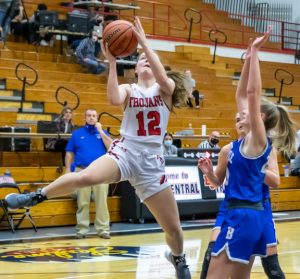 East Central’s Hope Fox (12) makes a Jordan-esque move to the basket en route to 18 points in the sixth-ranked Lady Trojans’ 63-18 Senior Night rout of EIAC rival Batesville Friday. (Sandy Mahoney)