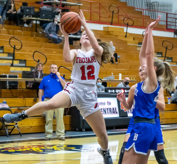 East Central’s Hope Fox (12) makes a Jordan-esque move to the basket en route to 18 points in the sixth-ranked Lady Trojans’ 63-18 Senior Night rout of EIAC rival Batesville Friday. (Sandy Mahoney)