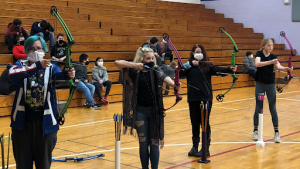 Maddie Kaiser, from left, Kaylee Greene, Angelyna Cannada, and Bella Hermann aim fort he target while practicing archery. Submitted Photo