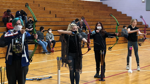 Maddie Kaiser, from left, Kaylee Greene, Angelyna Cannada, and Bella Hermann aim fort he target while practicing archery. Submitted Photo