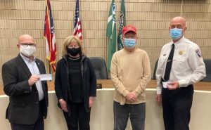 Harrison Mayor Bill Neyer, left, and Harrison Fire Chief Bill Hursong, accepting donations from Janet Keiful and Bill Floyd of the Veterans of Foreign Wars (VFW) Duwel Post 7570. Screenshot from ICRC TV