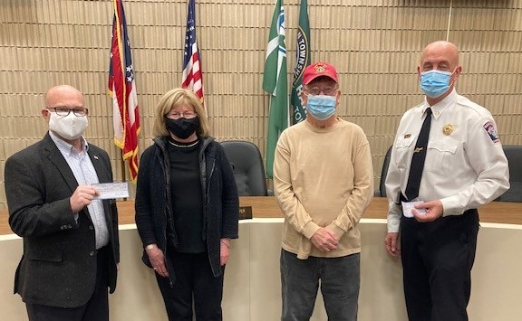 Harrison Mayor Bill Neyer, left, and Harrison Fire Chief Bill Hursong, accepting donations from Janet Keiful and Bill Floyd of the Veterans of Foreign Wars (VFW) Duwel Post 7570. Screenshot from ICRC TV