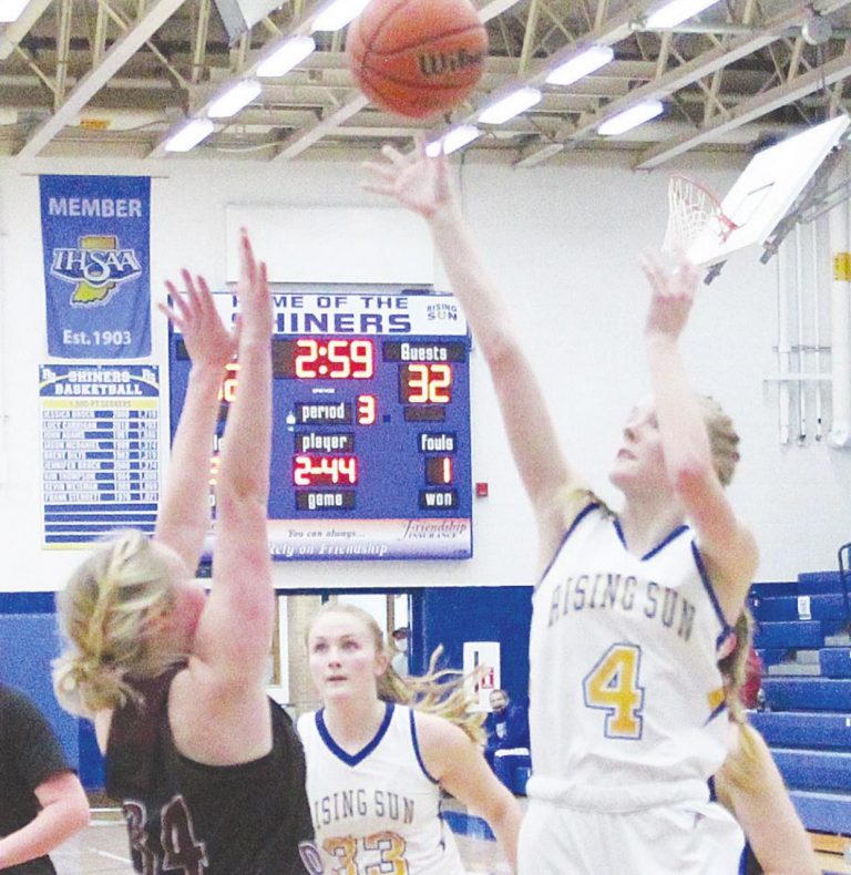 Freshman Jenna Peelman (4) shoots from the post while Rising Sun teammate Alyssa Simpson (33) crashes the boards in the Lady Shiners’ 51-43 loss to South Decatur in the regular season finale Saturday. MASON J. UHLMANSIEK