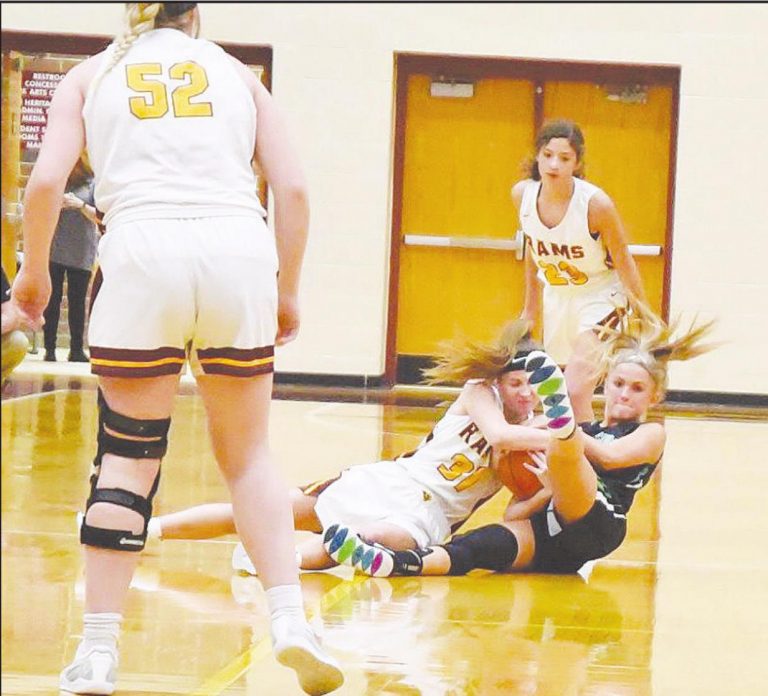 Wildcat Amy Tombragel battles Ross Ram Veronica Allen for the ball during their game Jan. 27. PHOTO BY SANDY MINOR