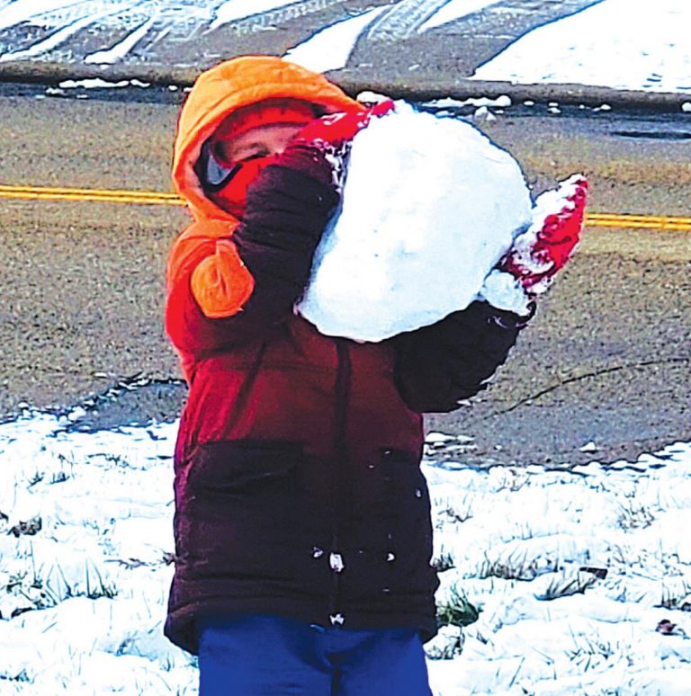 Gabe Wells, son of Bill and Jessica Wells and a kindergartner in Chandra Phillips’ class at OCEMS, ditched his brothers to play in the snow on his day off. He wrestles a giant snowball that he created. SUBMITTED PHOTO