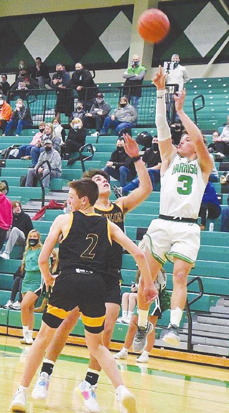 Mason Young shoots a jump shot over two Taylor High School defenders in the Wildcats game against the Yellow Jackets Feb. 9. PHOTO BY SANDY MINOR