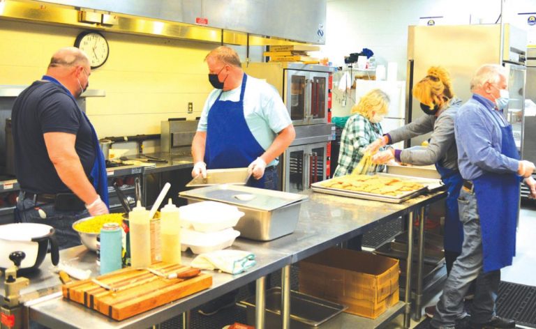 The St. Theresa Benedicta of the Cross Catholic Church Knights of Columbus and other volunteers were hard at work on Friday evening for the fish fry. HALIE BARGER/THE JOURNAL PRESS