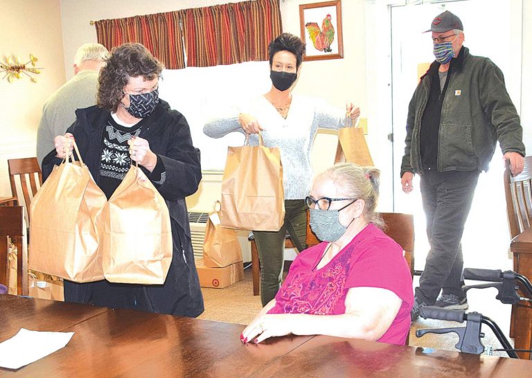 Lutheran Community resident Susan Kunkel receives her goodie bag from Beth Townsend of Good Shepherd Luther Church in Kenwood, Ohio. MARC EMRAL/THE REGISTER