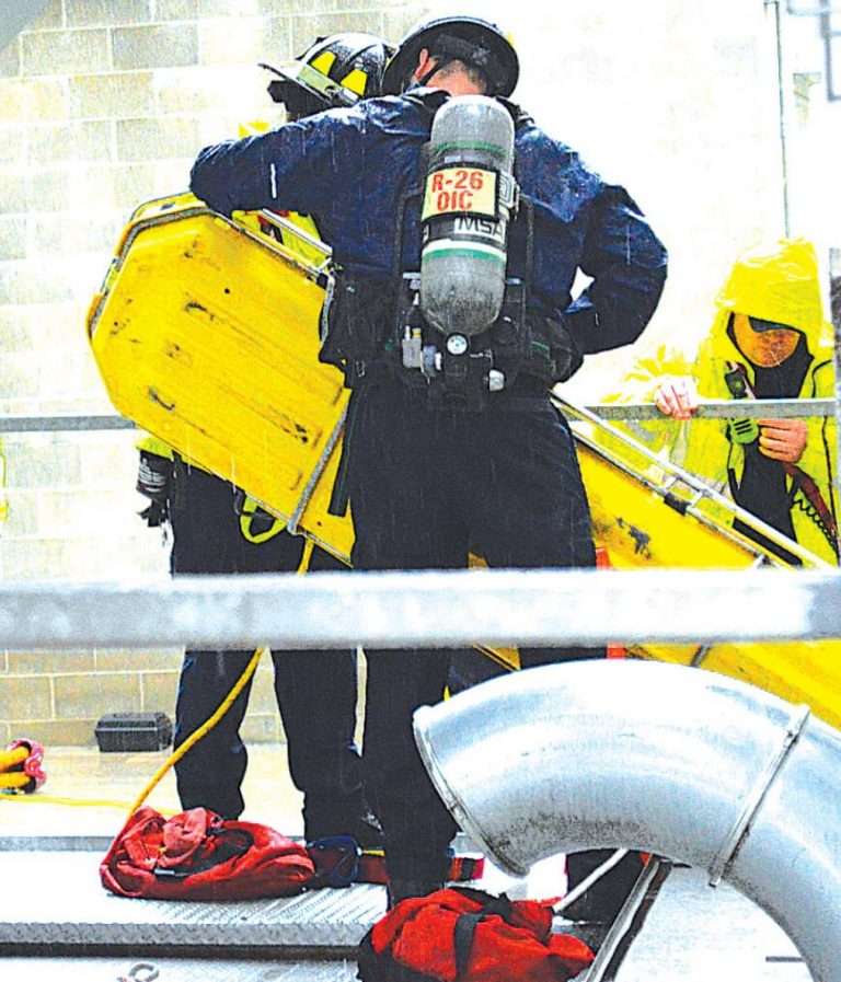 Rained poured down on the Hamilton County Urban Search and Rescue Task Force as it performed a training role play. HALIE BARGER/The Harrison-Press