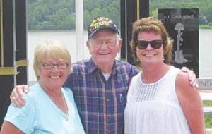 Bush White is accompanied by Paula Gentrup and Tammy Johns in front of the riverfront Veteran’s Memorial Tower that was being erected. “He was so proud that day,” said Johns. Below, White is with Gov. Eric Holcomb. SUBMITTED PHOTOS
