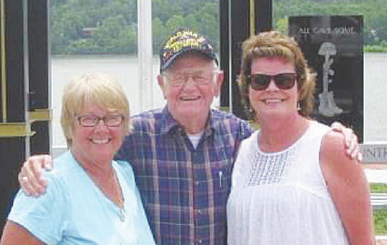 Bush White is accompanied by Paula Gentrup and Tammy Johns in front of the riverfront Veteran’s Memorial Tower that was being erected. “He was so proud that day,” said Johns. Below, White is with Gov. Eric Holcomb. SUBMITTED PHOTOS
