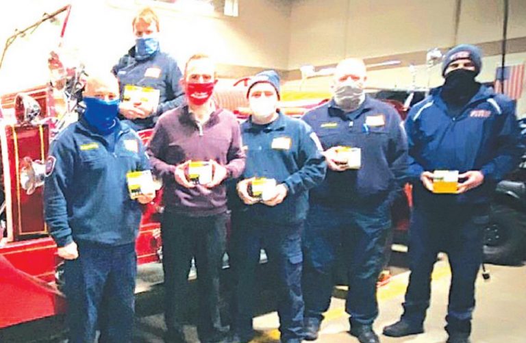 Eric Mayer, second from left in front, donated smoke alarms to the Harrison Fire Department. SUBMITTED PHOTO