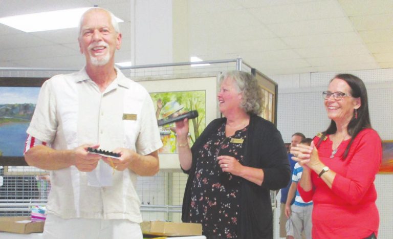 Gary Payne receives an award for his artwork from Marge Beinkemper and Chris Campbell at the 2019 spring show. SUBMITTED PHOTO