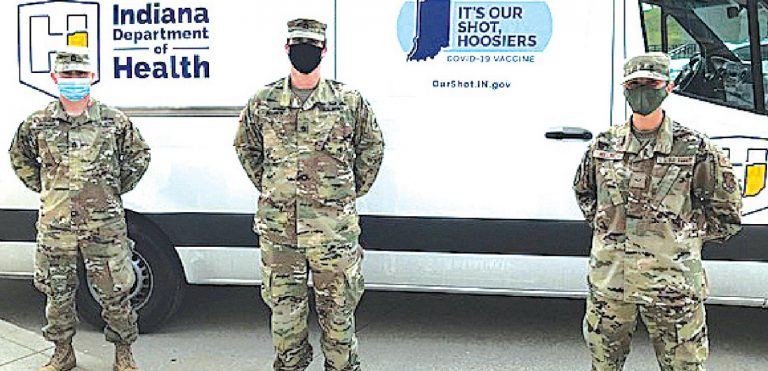 Part of the team working the mobile vaccination clinic in Lawrenceburg last week were, from left, Sgt. 1st Class Michael Smichowski, Staff Sgt. Michael Allison, both of the Army National Guard, and Senior Airmen Alysa Holloway, of the Air National Guard. MARC EMRAL/THE REGISTER
