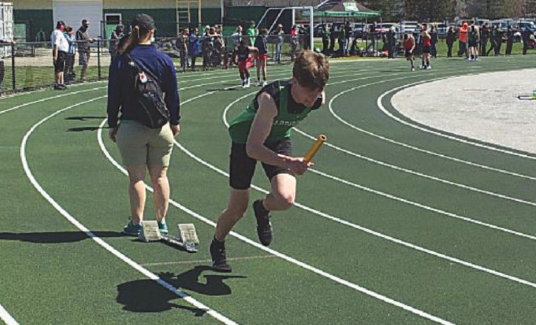 Jaxx Browning breaks from the block for the first leg of the boys fourby-200-meter relay in the Harrison All-Comers Meet March 27. PHOTO BY DICK MALONEY