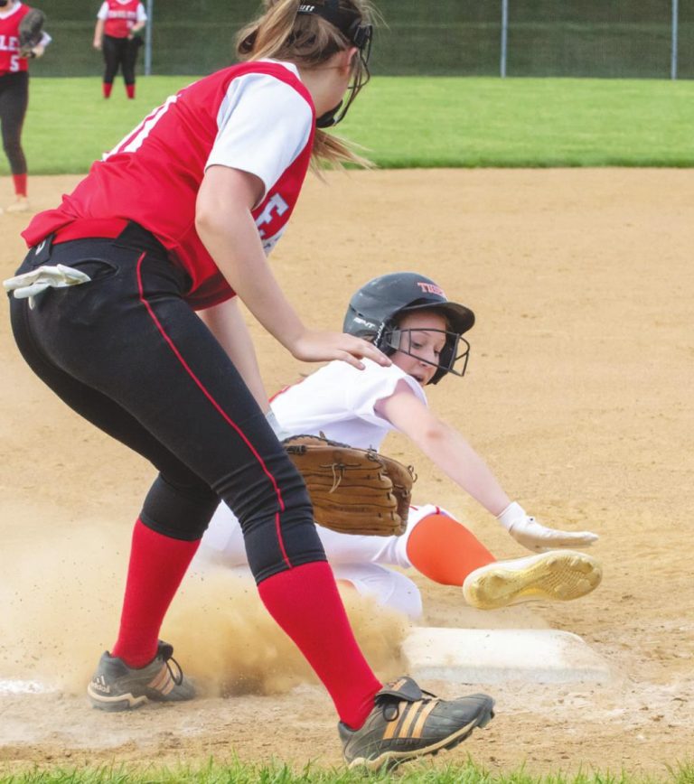 Lawrenceburg’s Haylee Palmer slides safely into third base in the Lady Tigers’ varsity softball victory over Jac-Cen-Del earlier this season. BETTY TAYLOR/TAYLORMADEPHOTOGRAPHY.COM