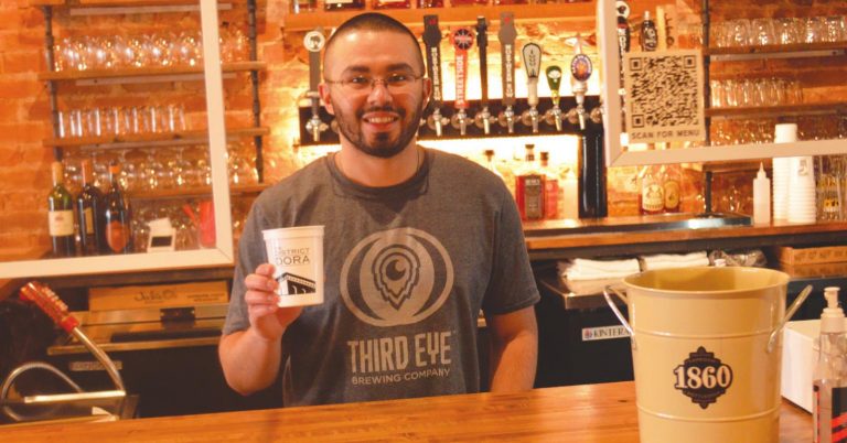 John Lohman, an employee at 1860 Taproom & Bottleshop, a participating business in the DORA, said people have been using the DORA more as the weather has gotten warmer. HALIE BARGER/The Harrison-Press