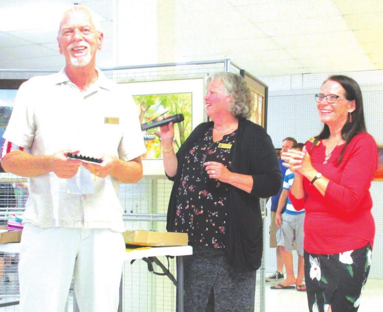 Gary Payne receives an award for his artwork from Marge Beinkemper and Chris Campbell at the 2019 spring show. SUBMITTED PHOTO