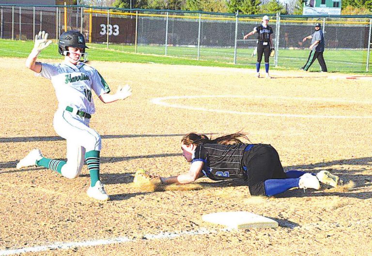 Karlie Davis beats the throw to third base in a softball game against Hamilton March 30. Davis would eventually score the winning run in Harrison’s 6-5 victory. PHOTO BY SANDY MINOR