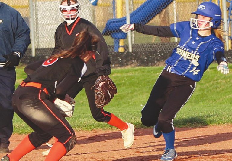 Rising Sun freshman Emma Russell (14) breaks into a slide in the varsity Lady Shiners’ 18-11 softball win over Lawrenceburg earlier this season at David & Butch Brown Stadium. MASON J. UHLMANSIEK