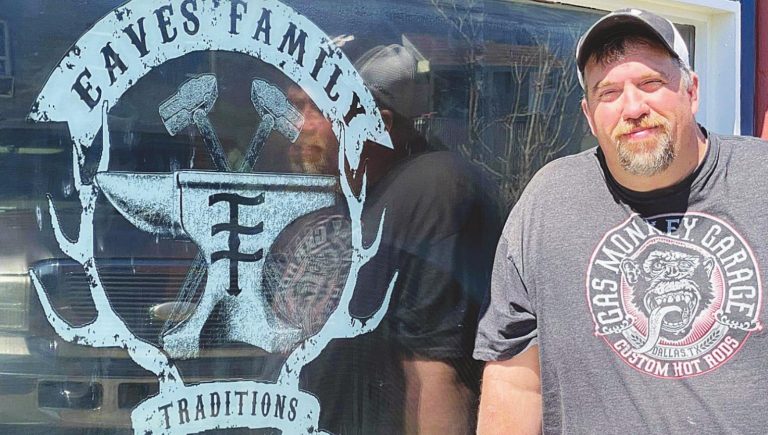 Nick Eaves stands next to his freshly labeled window that depicts his new shop, Eaves Family Traditions, at the Pendleton Art Center. SUBMITTED PHOTO
