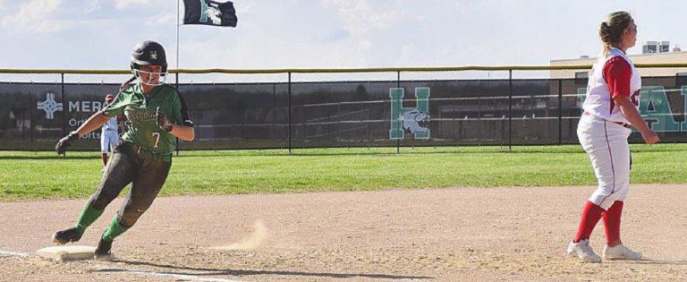 Harrison’s Kassidy Seger rounds third past a Talawanda defender in the Wildcats game April 5. PHOTO BY SANDY MINOR