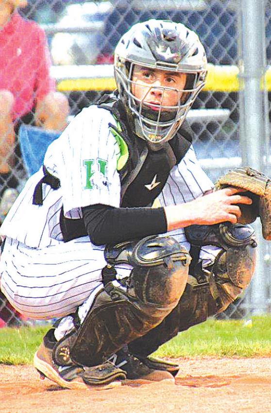 Harrison catcher Cade Combs looks over to his coach for the next pitch selection during a game against Lawrenceburg on April 3. PHOTO BY SANDY MINOR