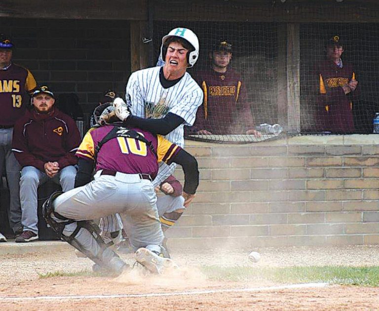 Grant Morse runs into the Ross catcher, who couldn’t hold onto the ball, during Harrison’s 6-4 victory over the Rams April 23. PHOTO BY SANDY MINOR