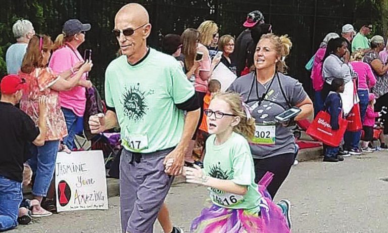 Denny Carrigan runs alongside his granddaughter Carrigan Friend. SUBMITTED PHOTO