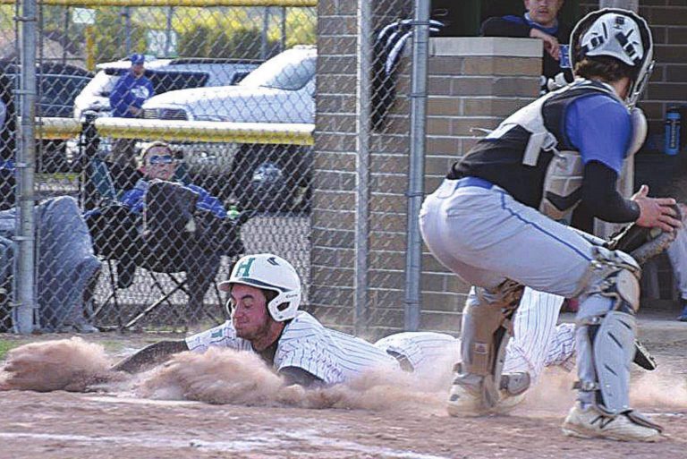 Wildcat DJ Diesman slides into home to score against the Big Blue of Hamilton May 13 at Harrison. PHOTO BY SANDY MINOR