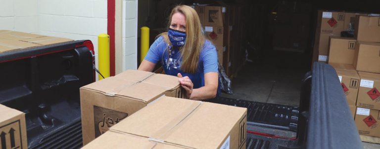 The United Way of Greater Cincinnati Southeast Indiana Director Karen Snyder loads hand sanitizer to deliver throughout Southeast Indiana. SUBMITTED PHOTO