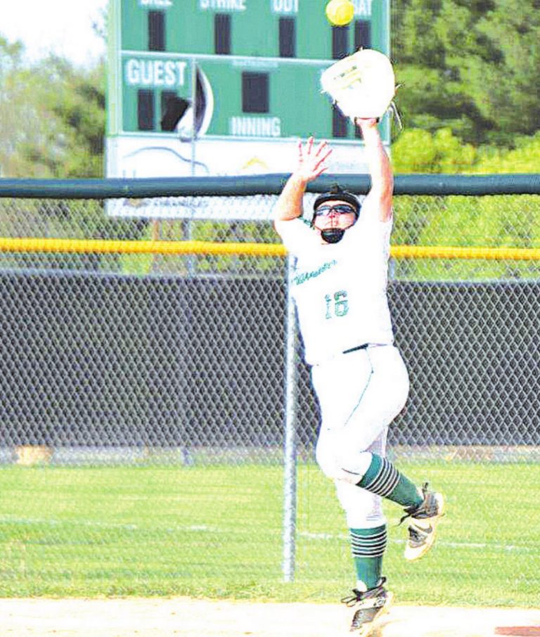 Harrison’s Rylee Kirkwood jumps high to snag a throw at first base during the Wildcats game versus Northwest April 27. PHOTO BY SANDY MINOR