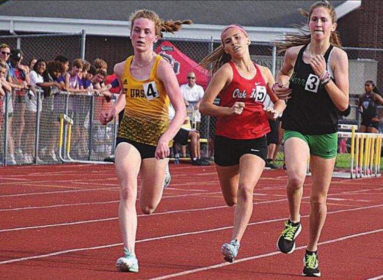 Natalie Kiefer takes the inside during her 1600 meter run during the district tournament. PHOTO BY SANDY MINOR
