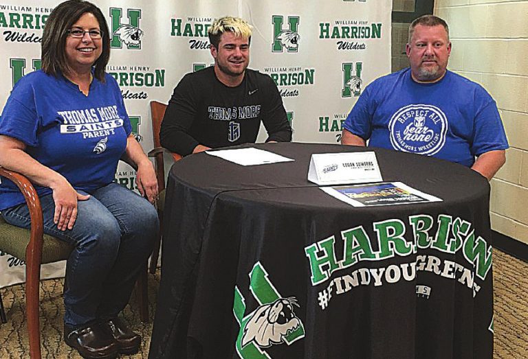 Logan Sowders with his parents after signing a letter-of-intent to wrestle at Thomas More University. PHOTO BY DICK MALONEY