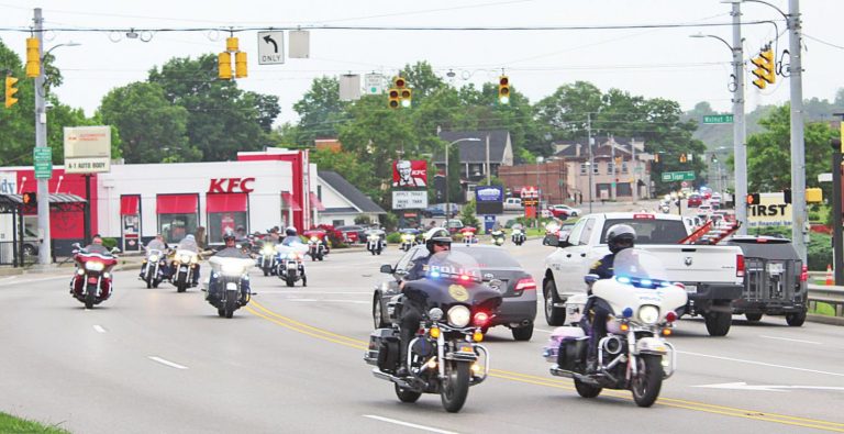 Police and other motorcyclists escort the truck containing the Wall That Heals through Lawrenceburg on its way to Harrison June 8. The Wall will be on display through 2 p.m. Sunday, June 13. MATT POPOVICH/The Register