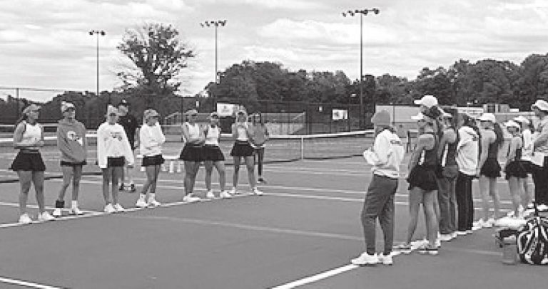 Lawrenceburg’s sectional and regional champion girls tennis team (left) lines up opposite unbeaten Sullivan (25-0) for introductions prior to Saturday’s IHSAA Semistate Championship. LHS ATHLETICS