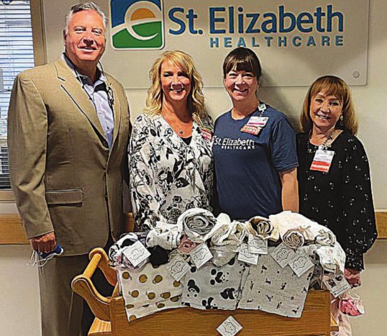 With blankets donated to the birthing center at St. Elizabeth Dearborn Hospital are, from left, Chris Carle, chief operating officer at St. Elizabeth Dearborn; Angela Roberts, vice president and chief nursing officer; Jacquie Riztmann, manager of the birthing center; and Claudia Richardt, a volunteer at St. Elizabeth Dearborn. SUBMITTED PHOTO