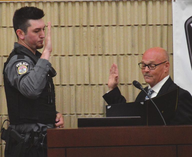 New Harrison Police Officer Lyric Hamlin is sworn in by Mayor Bill Neyer. HALIE BARGER/THE HARRISON-PRESS