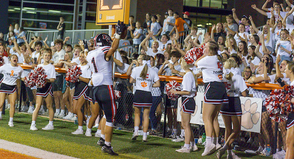 East Central’s Eli Aston (1) fires up the cheerleaders and end zone student section after his 6-yard TD run with 41.2 seconds left put a cap on the Trojans’ emphatic 34-6 season-opening win at Lawrenceburg Friday, Aug. 20. (Sandy Mahoney)